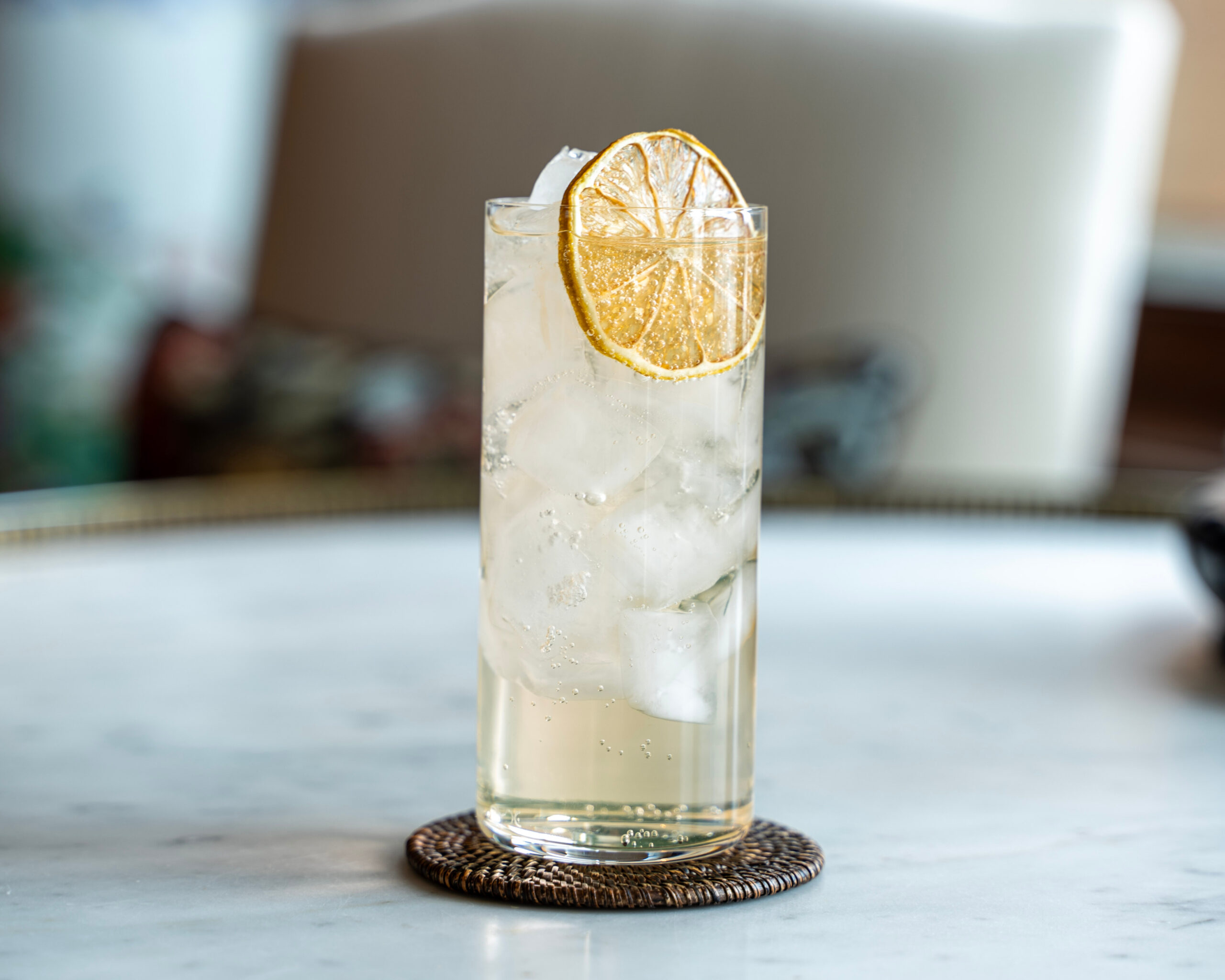 savory lemon spritz with sparkling water and lemon peel in a tall glass