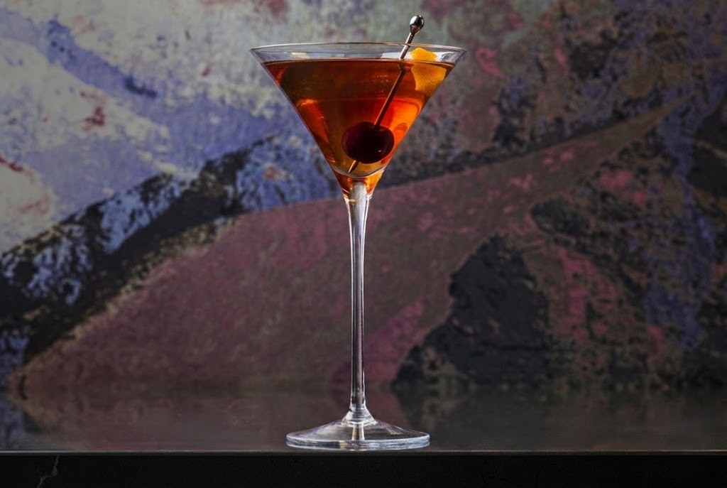 Manhattan cocktail in a coupe glass with a cherry garnish