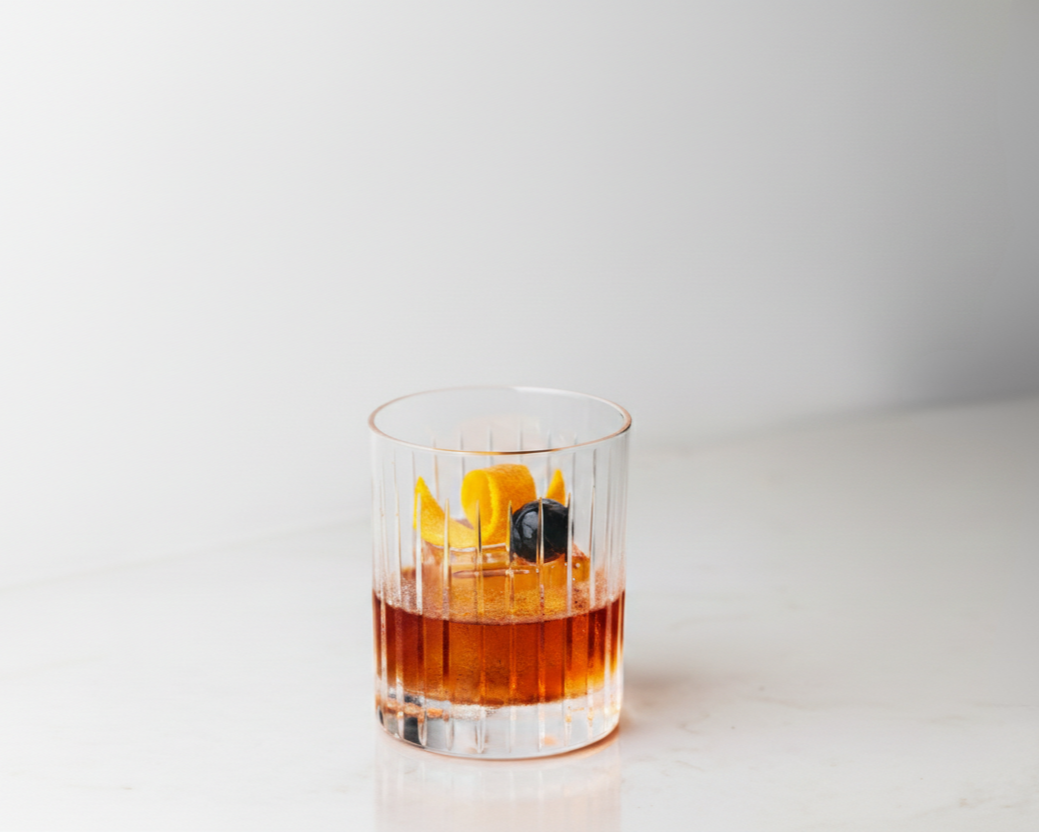Old Fashioned cocktail in a rocks glass with orange peel garnish