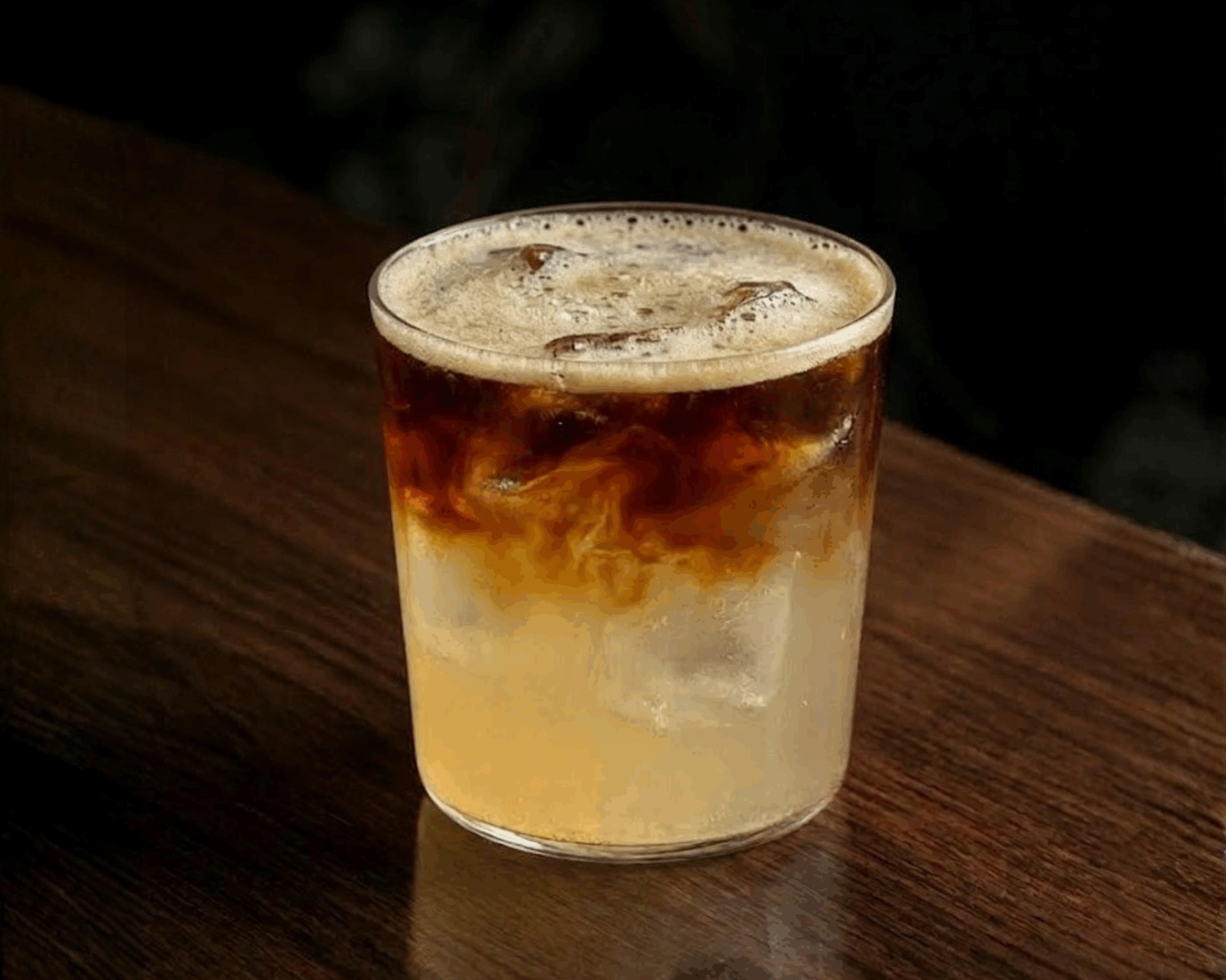 Dark and Stormy cocktail made with dark rum and ginger beer, served over ice with lime
