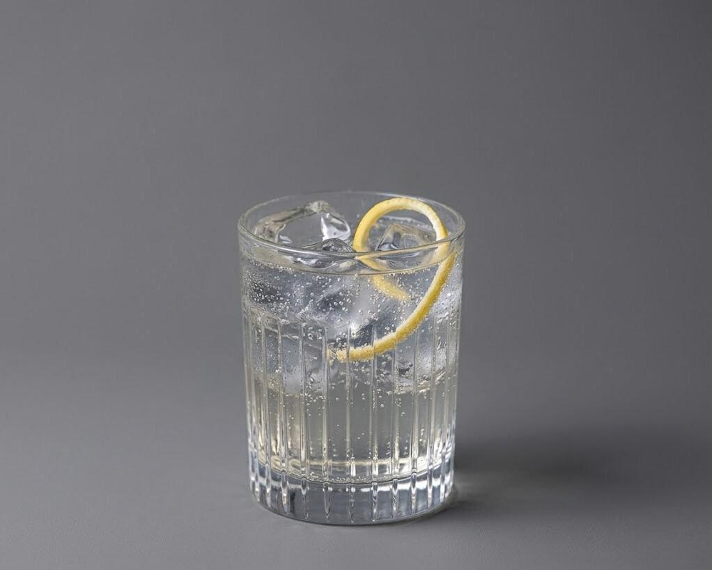 Jasmine lemon spritz mocktail served over ice with a lemon slice in a clear glass